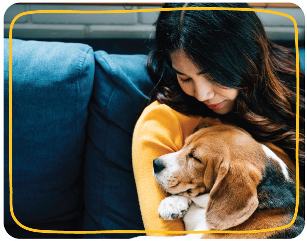 Pet parent cuddling a puppy at home, reflecting the emotional bond and trust that shape pet-parent decision making.